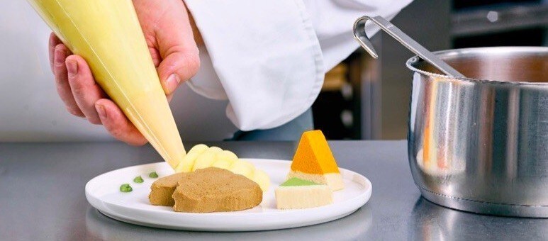 Aged Care chef plating a pureed dish Aged Care chef plating a pureed dish