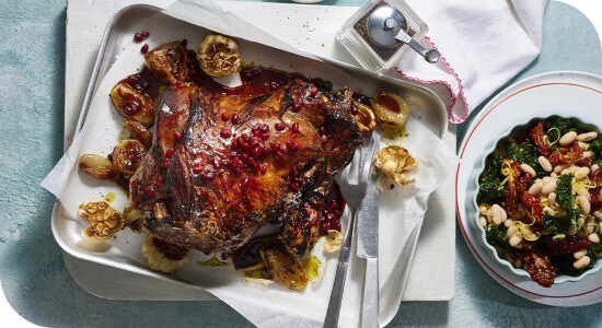 Roast lamb with pomegranate glaze, cannellini, and spinach salad