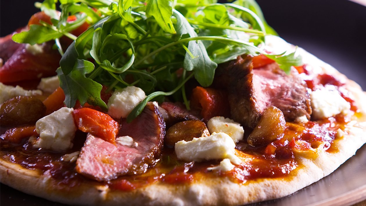 BBQ Prime Rib Pizza with garlic, peppers, onions, fetta, & rocket – Recipe