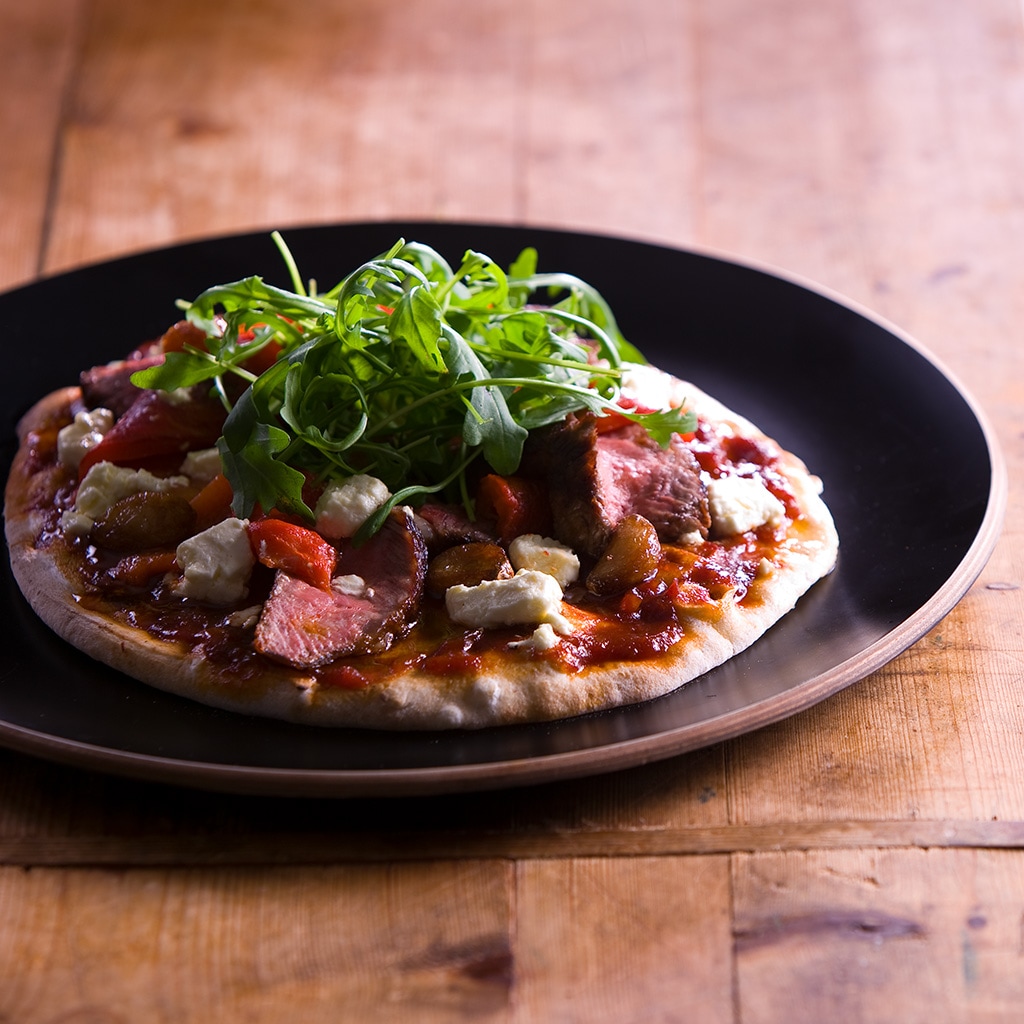 BBQ Prime Rib Pizza with garlic, peppers, onions, fetta, & rocket BBQ Prime Rib Pizza with garlic, peppers, onions, fetta, & rocket
